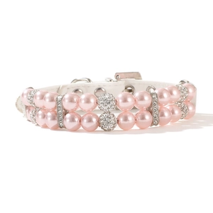 Detail of pink double-row pearl pet collar with rhinestone balls and white leather strap