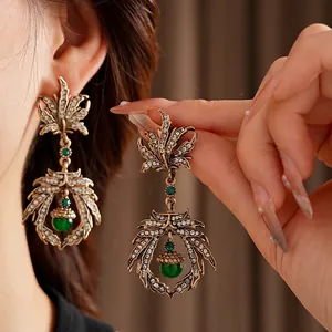 Vintage baroque leaf earrings in antique gold finish with crystals and green acorn beads