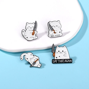 Funny cartoon white cat enamel pin set holding knives with be nice text on blue background