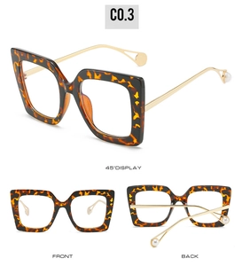 Detail view of large square tortoiseshell glasses frame with elegant pearl temple accents