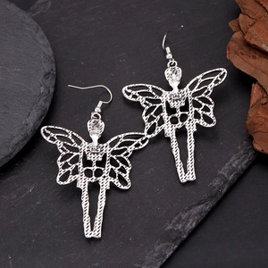 Detailed view of silver butterfly wing fairy earrings with gothic hollow design