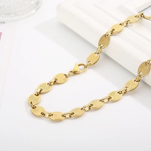 Macro view of 18k gold plated stainless steel coffee bean link chain with lobster clasp