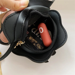 Black PU leather mini flower crossbody bag for girls showing compact interior capacity