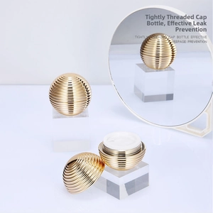 Macro view of 30g gold spherical cosmetic jar with screw cap and airtight seal