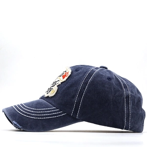 Detail of vintage washed blue cotton baseball cap featuring Dog Only frayed patch and white stitching