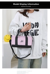 Close-up of pink and black nylon cylinder bag with JLP logo and crossbody strap