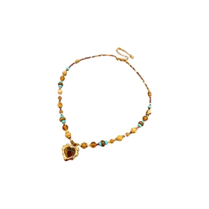 Bohemian heart pendant necklace with turquoise beads and gold-edged brown stone charm