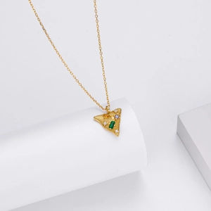 Detailed view of a gold triangle pendant set with multicolored zircon on a white stand