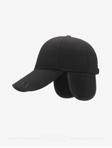 Detail of winter wool baseball cap with Nefelibata embroidery and ear flaps in black