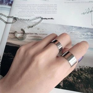 Detailed view of polished wide band stainless steel rings with a high mirror finish