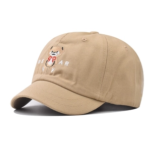 Close-up of bear embroidery and twill cotton texture on khaki short brim baseball cap