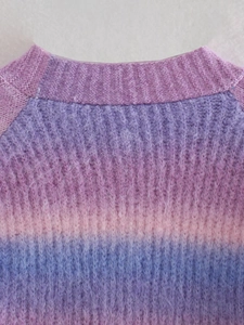 Detailed close-up of fuzzy tie-dye knit sweater in pastel purple pink and blue gradient