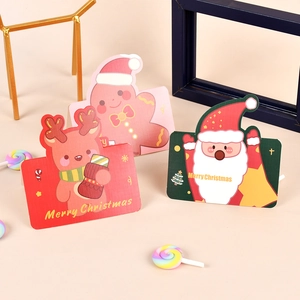 Three Christmas cards with Santa, reindeer, and gingerbread man on studio background