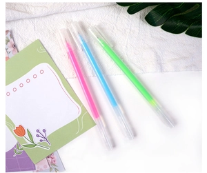 Close-up of three colorful gel pens in pink, blue, and green for DIY scrapbooking