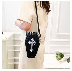 Detail of the gothic coffin cross bag featuring black PU leather and gold zippers