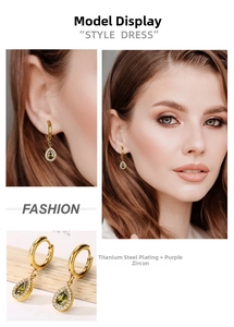 Detail of tear-drop earrings with pear-cut green zircon and gold titanium plating