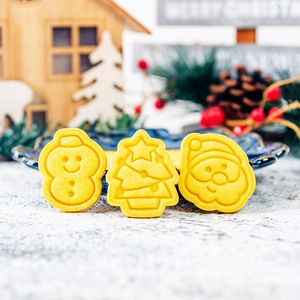 Yellow Christmas cookie mold set with snowman, tree and Santa Claus shapes for baking