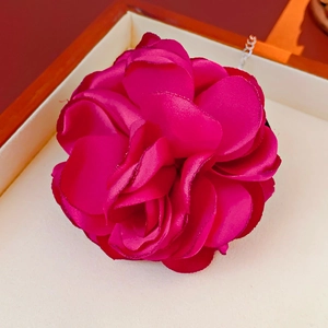 Detailed close-up of fuchsia flocked floral necklace with soft velvet texture and silver chain