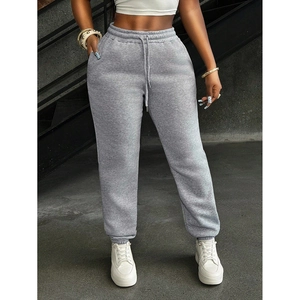 Detail view of light grey women's sweatpants featuring high waist drawstring and ribbed cuffs