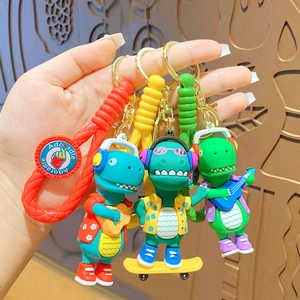 Cartoon dinosaur keychains with sports theme featuring skateboards and musical instruments