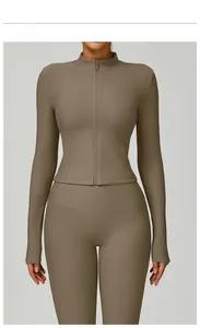 Close-up of light coffee ribbed knit yoga jacket with high neck zipper and slim fit texture