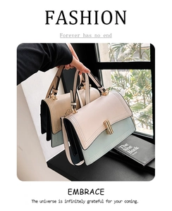 Détail de sacs bandoulière bicolores stylés en beige et vert avec fermoirs métalliques