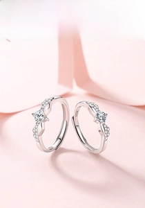 Close-up of S925 sterling silver couple rings with princess and round cut center stones