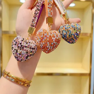 Detailed view of heart-shaped keychains with colorful rhinestones and metal lobster clasp