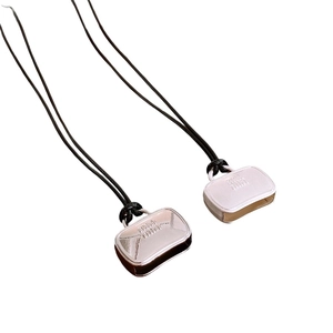 Minimalist wax cord necklace with embossed letter pendants on a clean white background