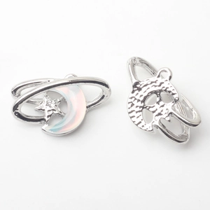 Close-up of silver crescent moon and star alloy pendant with iridescent resin inlay