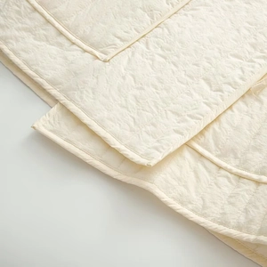 Detail of wave quilted stitching and beige cotton fabric texture on casual autumn wear