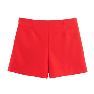 Detailed flat lay of red high-waisted casual shorts featuring smooth fabric texture