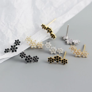 Macro shot of s925 silver flower stud earrings featuring various gem and finish options