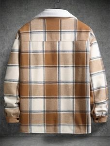 Detail of plaid jacket with white fleece collar and ribbed cuffs on grey background