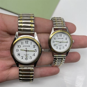 Close-up of elastic quartz watches with gold and silver bands and large number dials