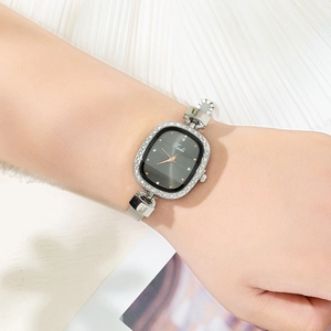 Close-up of Tadi silver mesh strap watch with rhinestone bezel and black oval dial