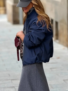 Detail of navy blue bomber jacket fabric texture and ribbed cuffs for a stylish look