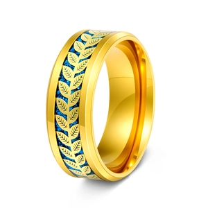 Macro shot of gold stainless steel ring featuring blue glitter inlay and olive leaf texture