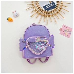 Detail of purple sequin backpack for girls featuring a heart-shaped transparent glitter pocket