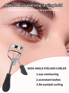 Macro detail of wide-angle stainless steel eyelash curler with black rubber pad