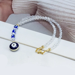 Blue evil eye beaded bracelet with clear faceted beads and gold metal heart charm
