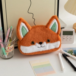 Close-up of cute plush fox pencil case on a study desk with creative stationery items