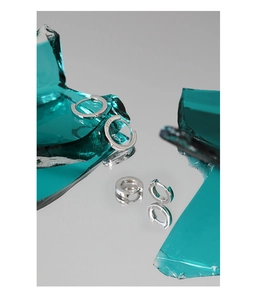 Detail of S925 sterling silver hoop earrings with clear hallmark on artistic glass