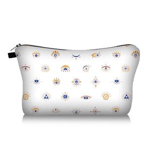 Detailed view of evil eye pattern makeup bag with blue and orange geometric patterns