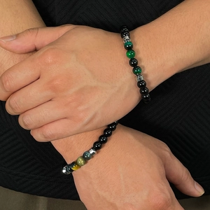 Close-up of men's beaded bracelets with natural tiger eye stones and silver metal beads