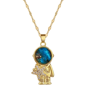 Titanium astronaut necklace with gold finish, blue star stone, and diamond-studded star