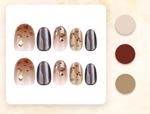 Detail of leopard print press-on nails with amber tones and luxury diamond embellishments