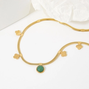 Gold snake chain necklace featuring solid clover charms and a green gemstone pendant