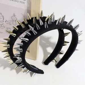 Close-up of punk style wide headband featuring metallic conical studs and handmade label