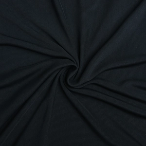 Close-up of black breathable mesh fabric texture and draped ruffled dress material